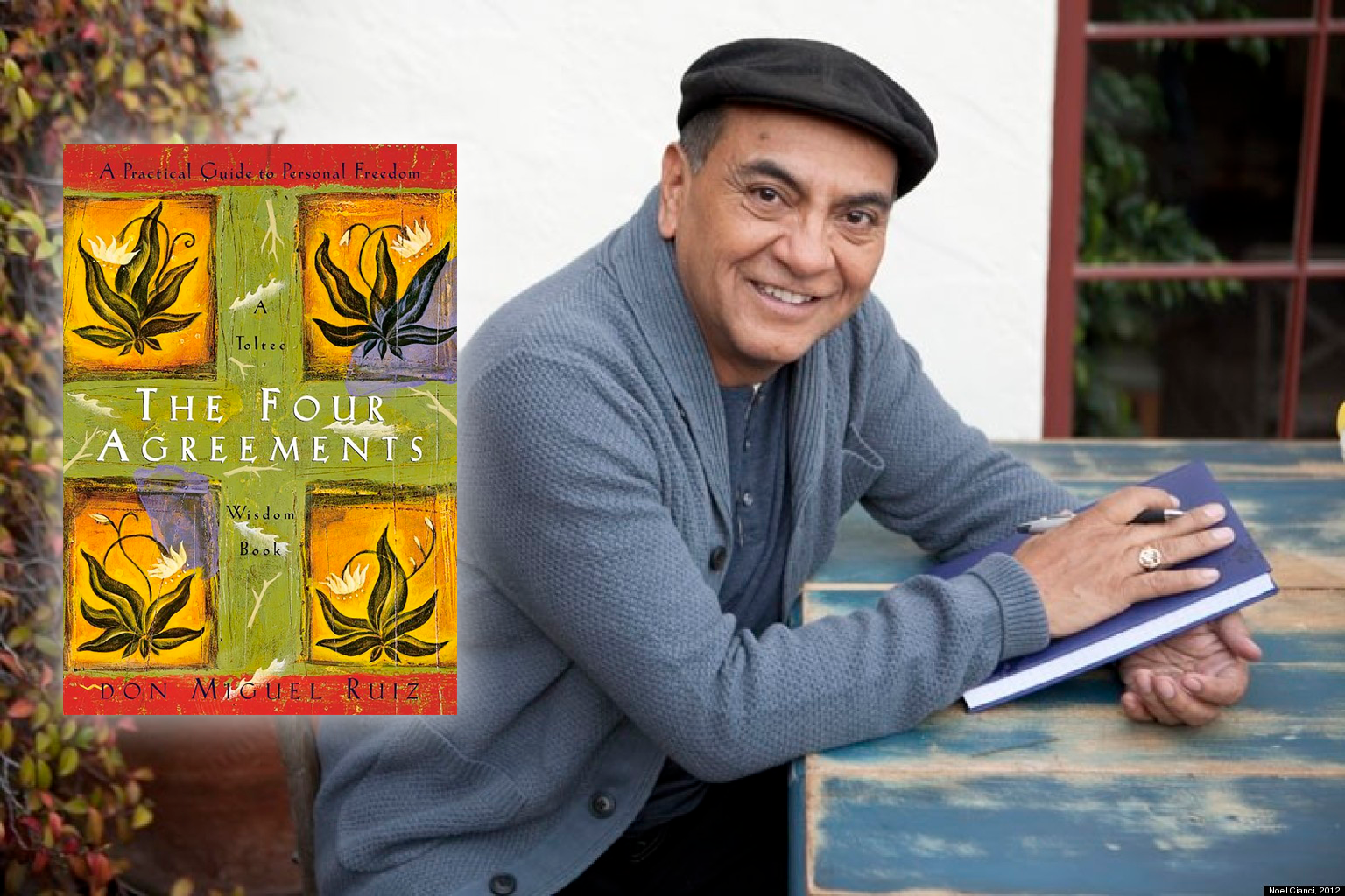 Don Miguel Ruiz, author of The Four Agreements, holding a pen and a hardcover book