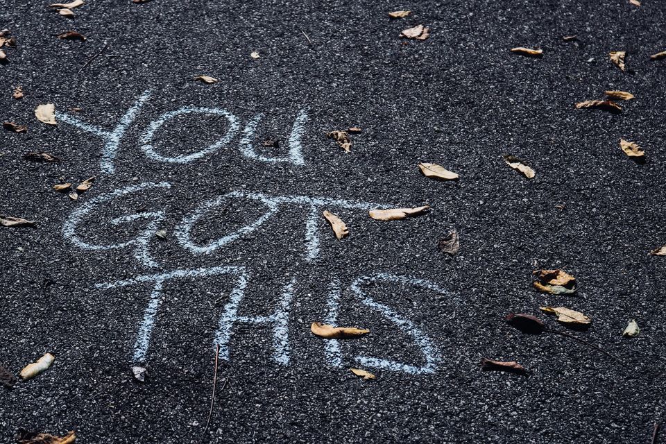 Sidewalk chalk writing that says, "You Got This"